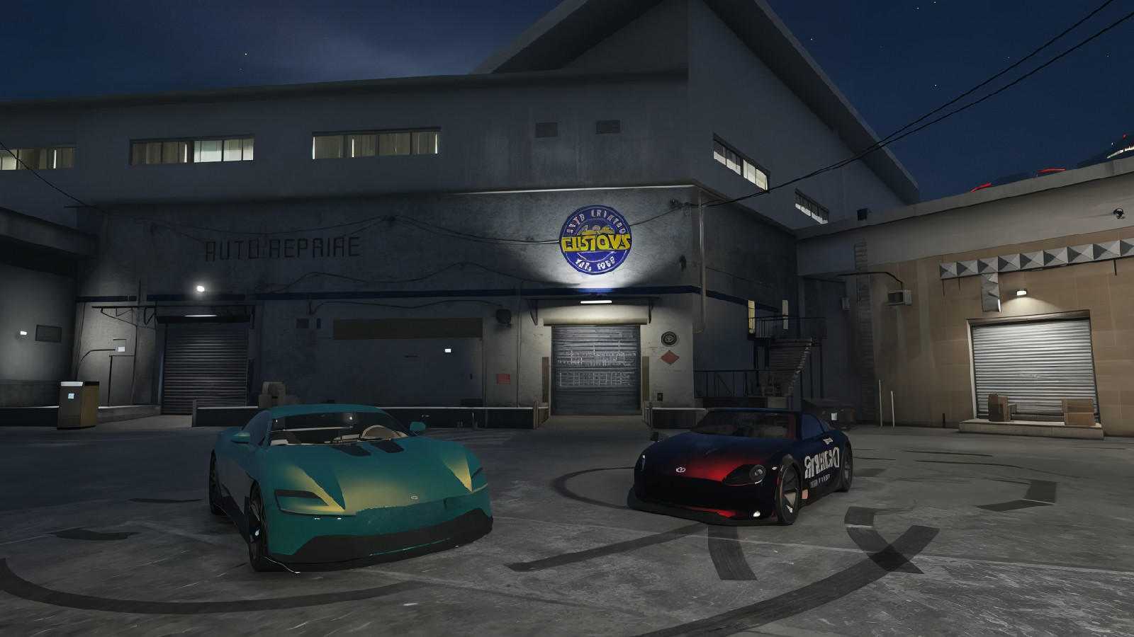 Two cars parked in front of a building at night