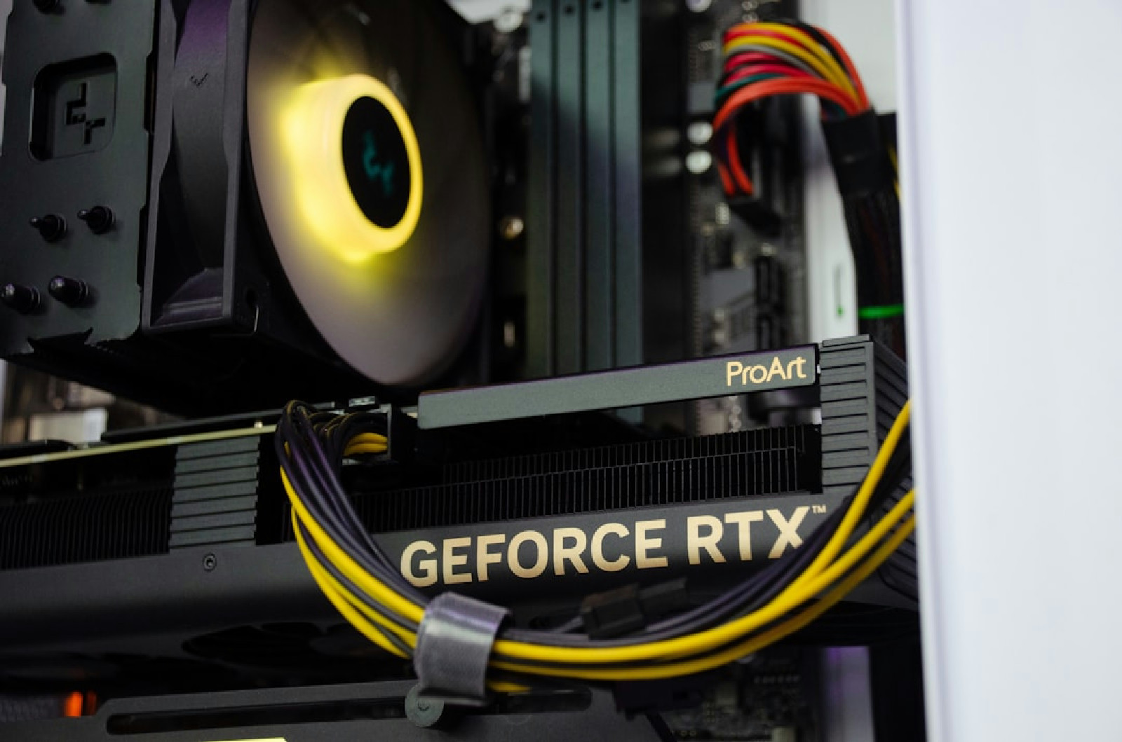 A close up of a computer case with a fan and modern hardware components