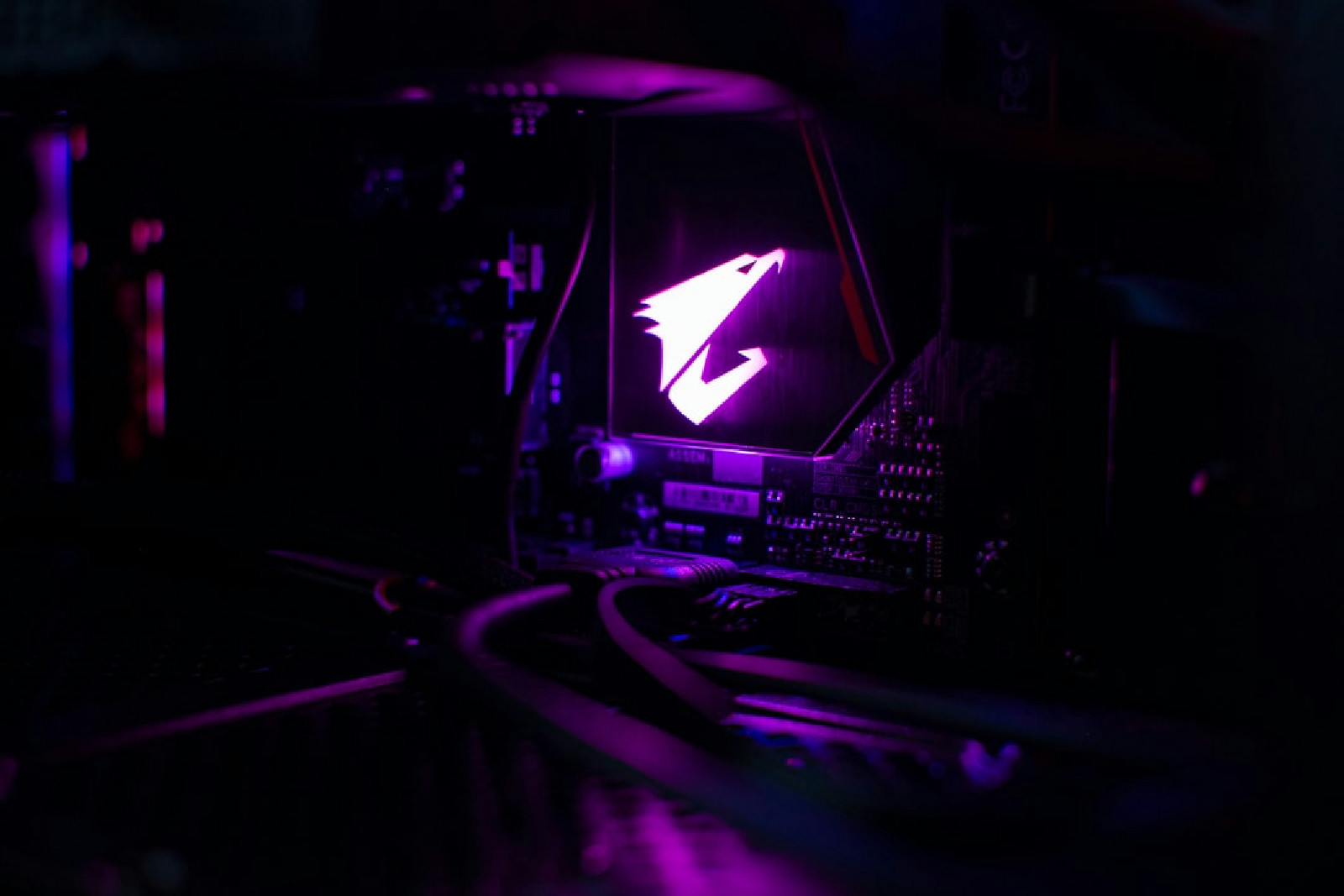 A close up of a high-end RTX 5090 Aorus GPU in a dark gaming PC setup