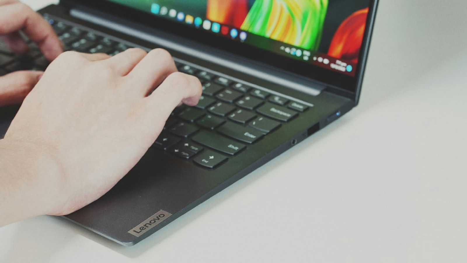 Close-up of a person interacting and typing on a modern computer interface