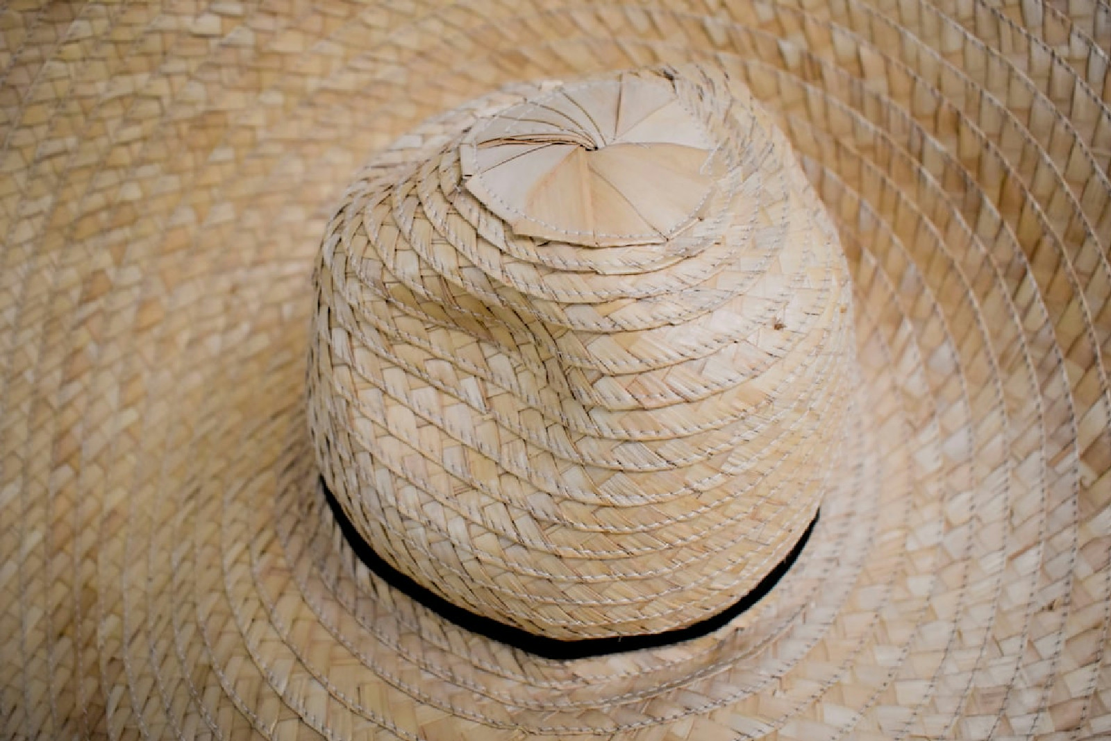 a straw hat with a bow on top of it