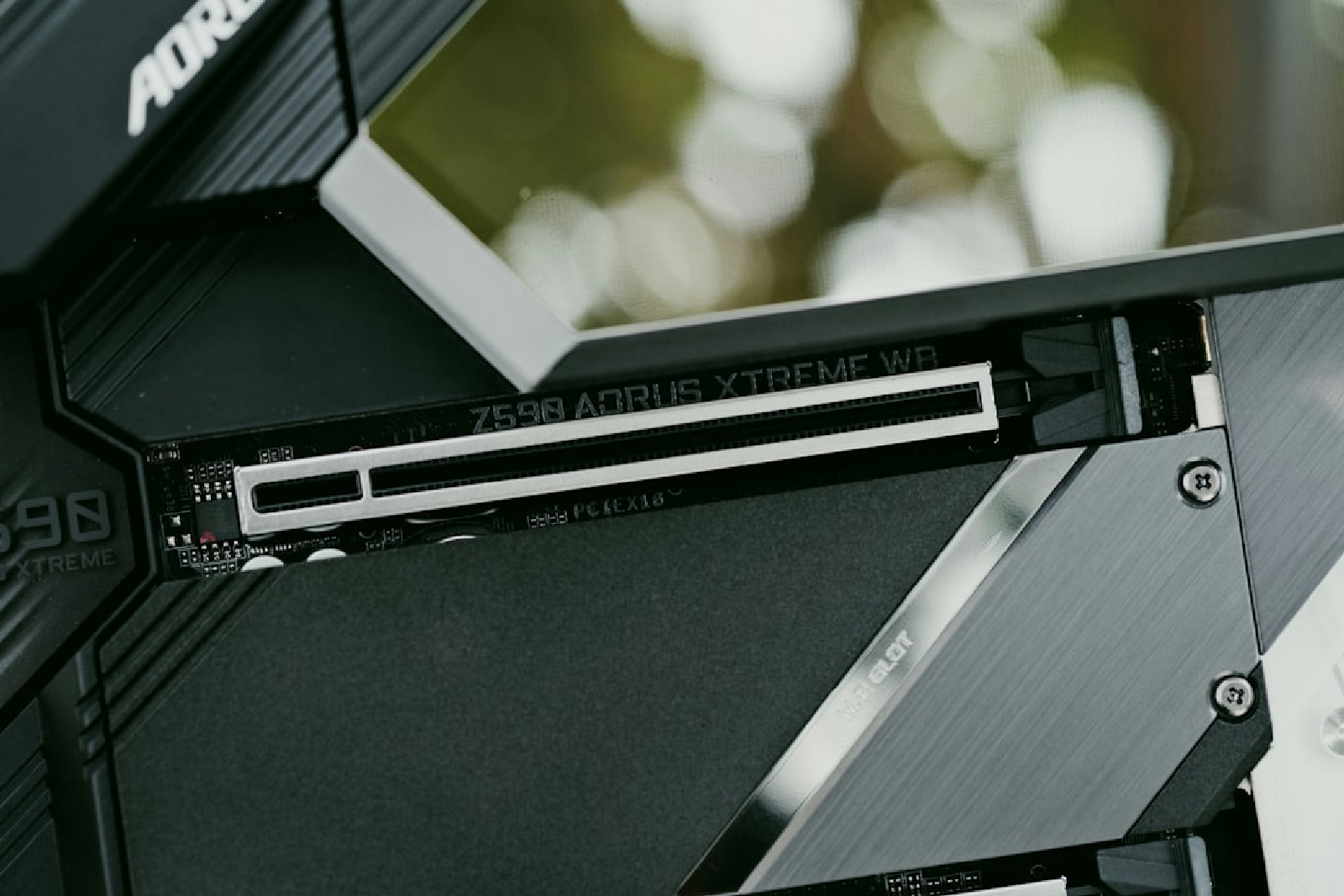 Close up of a computer with a large screen on top of it